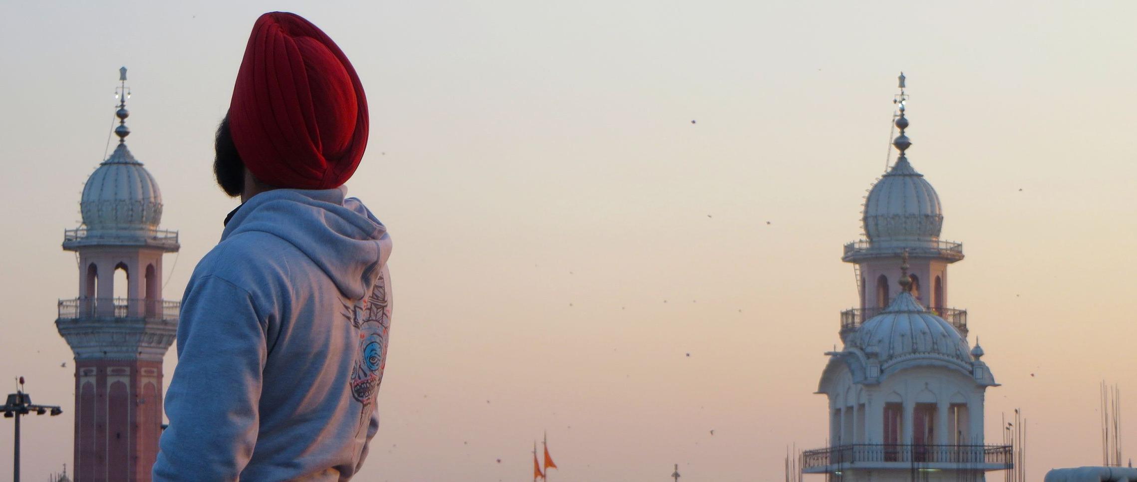 A photo taken during the India j项 study tour in 2015. A student poses in front of landmarks i...